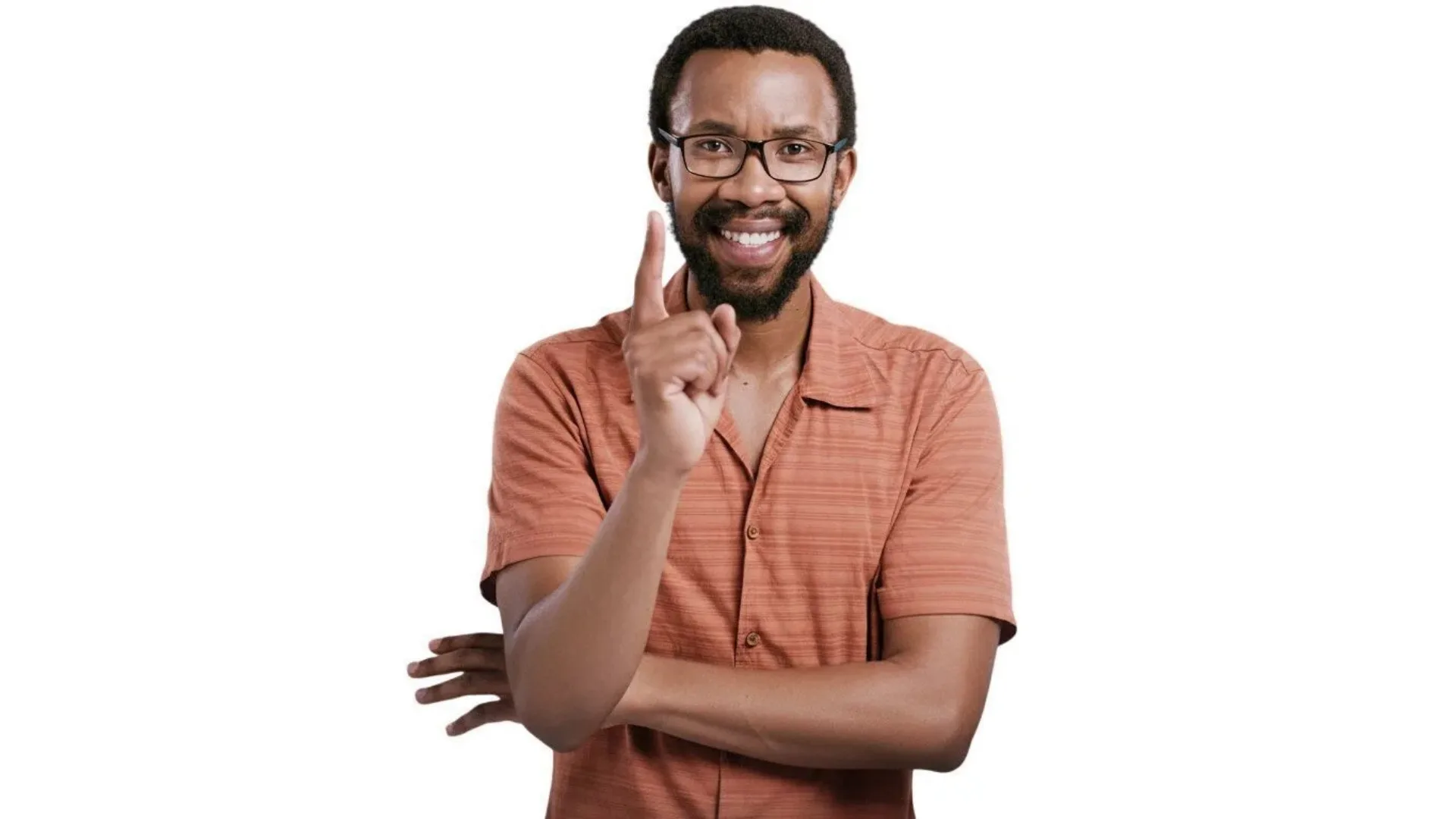 Smiling man wearing glasses and orange shirt pointing finger at camera against white background, professional portrait