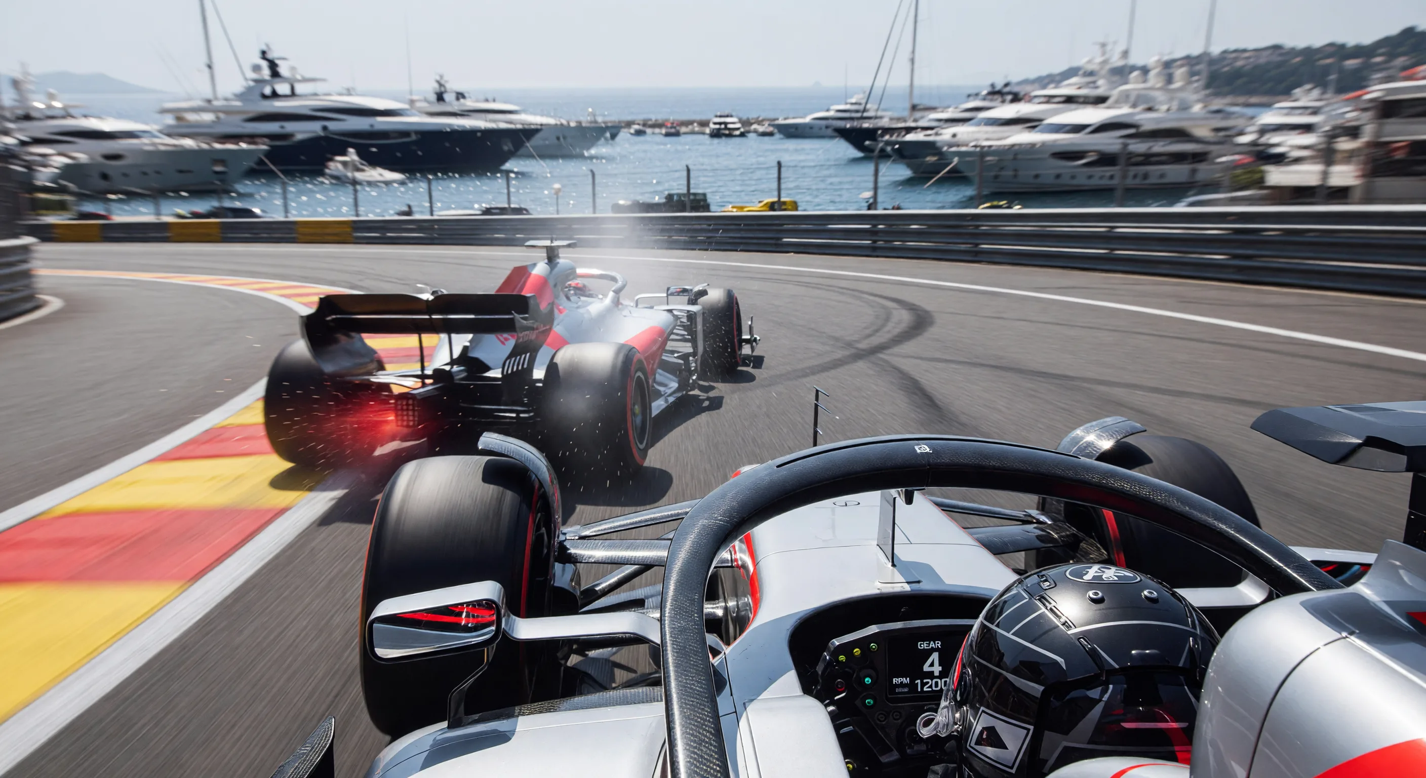 there are two racing cars driving on a race track near a marina