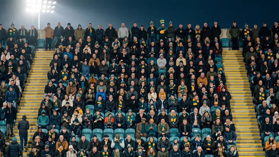The generated stand: a packed night crowd in teal and saffron