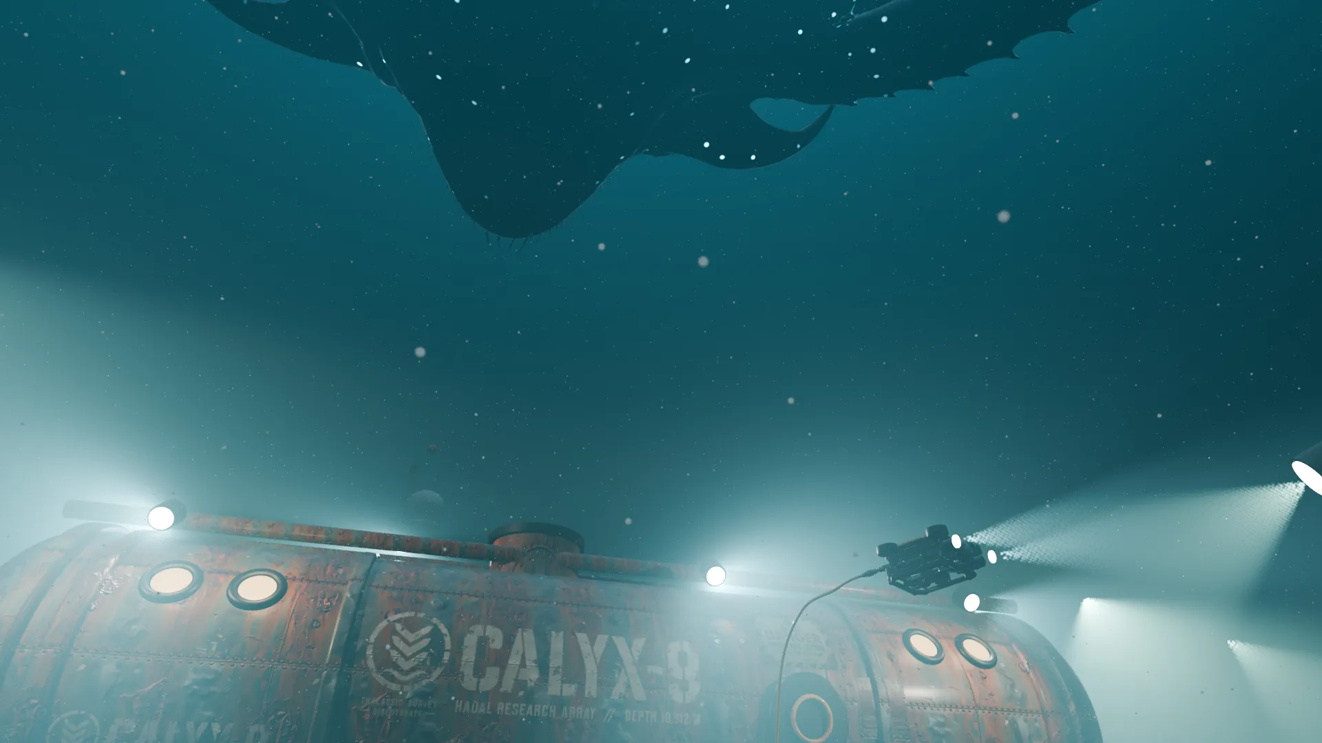 A colossal creature with glowing photophores glides over a rusted research station on the sea floor, floodlights cutting through drifting marine snow