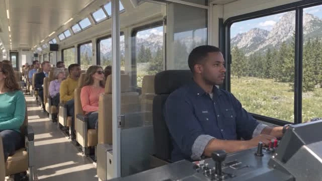 A frame from the finished Seedance movie: navy-clad driver, controls and passengers behind him