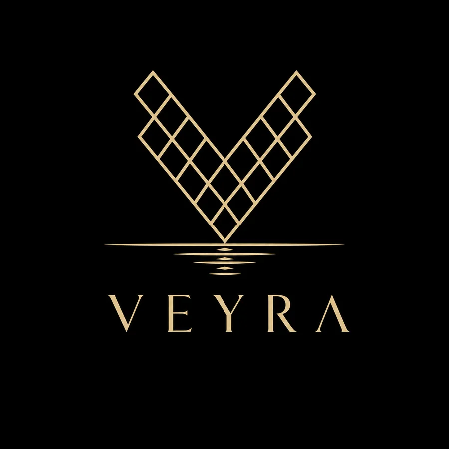 Gold VEYRA logo, a lattice V over water lines, on black