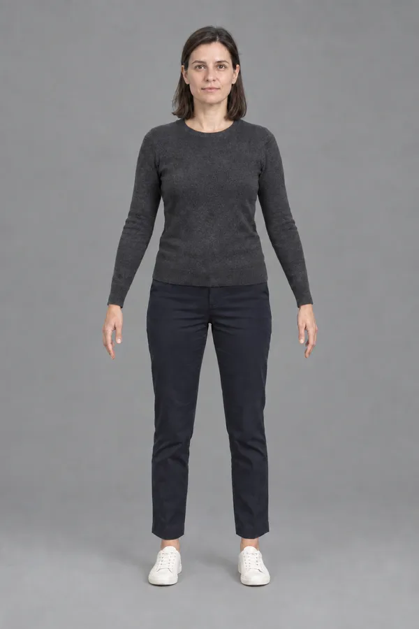 Concept of visitor A: a woman in a charcoal sweater, navy trousers and white sneakers, A-pose