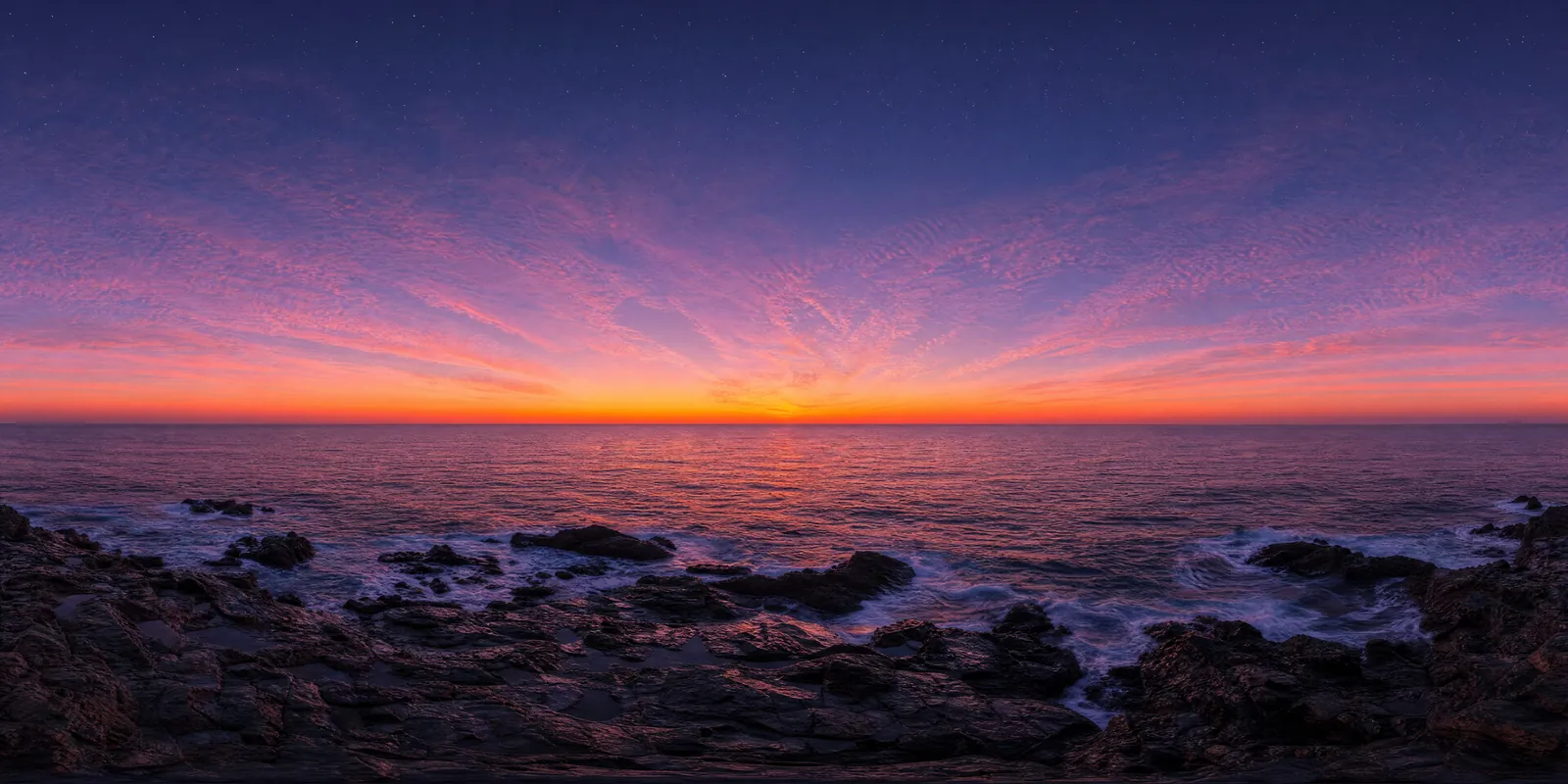 A 360 panorama of a dusk sky over the sea, orange at the horizon fading to violet