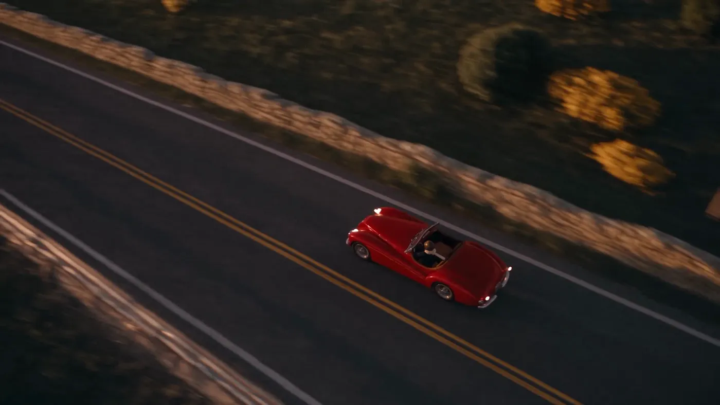 Seedance 2.5, frame 220: the car from above on real asphalt beside a stone wall
